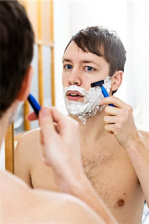 simsearch:693-06019176,k - Young man in front of a mirror. Stock Photo - Premium Royalty-Free, Code: 6102-03904851