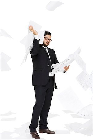 Businessman throwing paper around him. Stock Photo - Premium Royalty-Free, Code: 6102-03904883