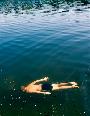 preadolescent bathing - A boy swimming, Sweden. Stock Photo - Premium Royalty-Free, Code: 6102-03904942