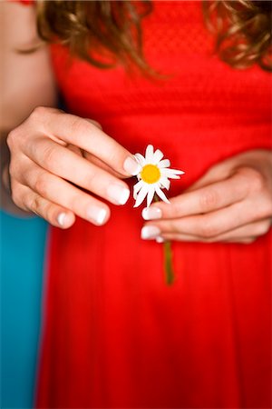 simsearch:633-01273290,k - Girl in a red dress holding a flower. Stock Photo - Premium Royalty-Free, Code: 6102-03904948