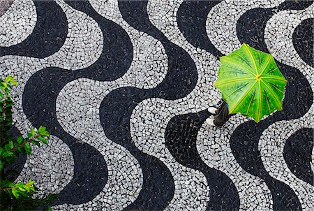 standing in the rain photography - Woman standing under an umbrella, Brazil. Stock Photo - Premium Royalty-Free, Code: 6102-03905170