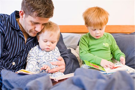 simsearch:6102-07602586,k - Father reading books with his children, Sweden. Stock Photo - Premium Royalty-Free, Code: 6102-03905240