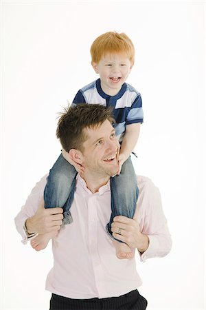 father carrying son on shoulder - Father carrying his son on the shoulders. Stock Photo - Premium Royalty-Free, Code: 6102-03905220