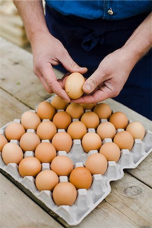 simsearch:6102-03905363,k - Farmer showing a box of eggs. Stock Photo - Premium Royalty-Free, Code: 6102-03905353