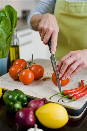 Woman cutting up vegetables, Sweden. Stock Photo - Premium Royalty-Free, Code: 6102-03905479