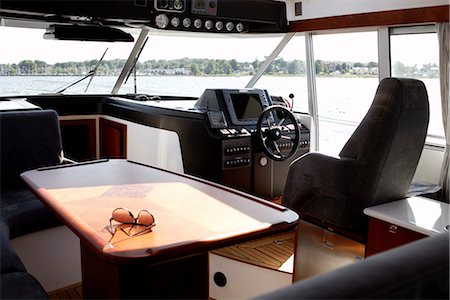 steering wheel boat - Sunglasses in boat cabin Stock Photo - Premium Royalty-Free, Code: 6102-03905693