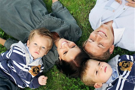 family on grass top view - Family lying on grass Stock Photo - Premium Royalty-Free, Code: 6102-03905947