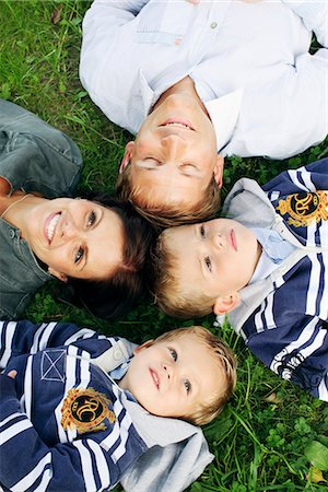 father son lying grass - Family lying on grass Stock Photo - Premium Royalty-Free, Code: 6102-03905948