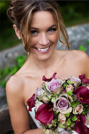 Bride holding bouquet, looking at camera Stock Photo - Premium Royalty-Free, Code: 6102-03905935