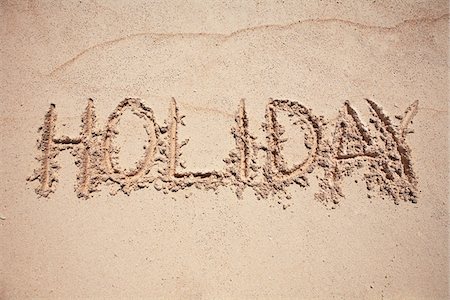 Text  HOLIDAY written on sand Stock Photo - Premium Royalty-Free, Code: 6102-04929345