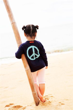 signage on the beach - Girl standing on beach Stock Photo - Premium Royalty-Free, Code: 6102-04929410