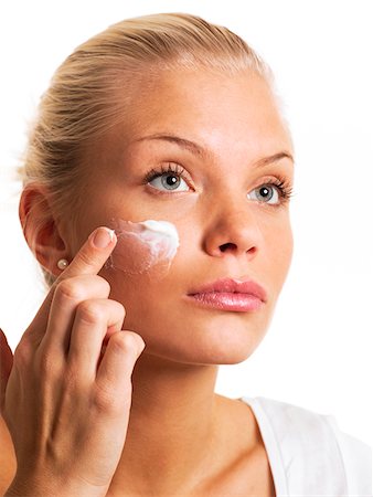 simsearch:614-06442357,k - Young woman applying sun cream on face, close-up Stock Photo - Premium Royalty-Free, Code: 6102-04929776