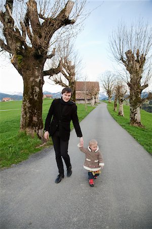 switzerland people on road - Father and daughter walking hand in hand Stock Photo - Premium Royalty-Free, Code: 6102-04929711