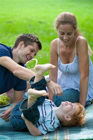 family picnic blanket - Mid adult parents playing with son Stock Photo - Premium Royalty-Free, Code: 6102-04929886