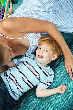 simsearch:6102-03829029,k - Mother with son lying on blanket Stock Photo - Premium Royalty-Free, Code: 6102-04929893