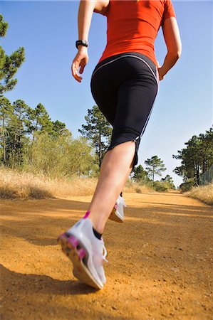 sneaker leg - Young woman jogging, low section Stock Photo - Premium Royalty-Free, Code: 6102-05655452