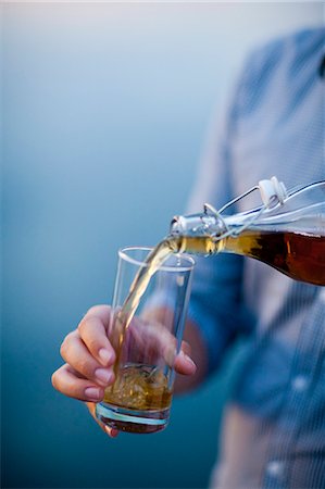 simsearch:6102-05655416,k - Man pouring wine into glass, close-up Stock Photo - Premium Royalty-Free, Code: 6102-05655400
