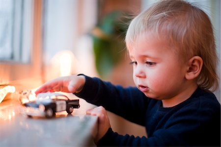 pictures of baby face side profile - Boy playing with toy car Stock Photo - Premium Royalty-Free, Code: 6102-05603690