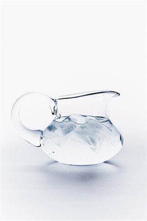 pitchers nobody - Close up of water with ice cubes in jug on white background Stock Photo - Premium Royalty-Free, Code: 6102-05802581