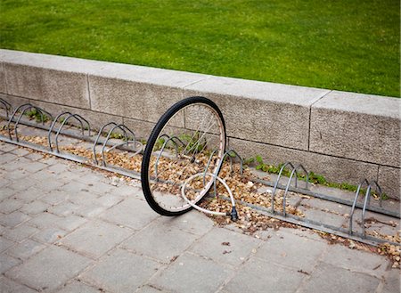 simsearch:614-09211440,k - Bicycle wheel locked to bicycle stand Stock Photo - Premium Royalty-Free, Code: 6102-05802642