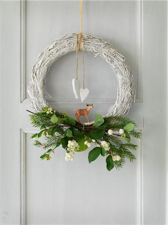 Close up of Christmas wreath on door Stock Photo - Premium Royalty-Free, Code: 6102-05802621