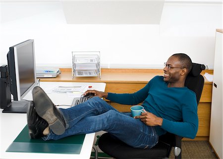 Man relaxing at desk in office Stock Photo - Premium Royalty-Free, Code: 6102-05955953