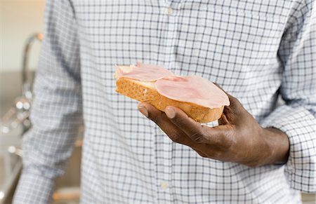 simsearch:6102-03905089,k - Close up of man''s hand holding sandwich Stock Photo - Premium Royalty-Free, Code: 6102-05955983