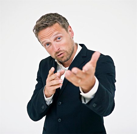 Studio portrait of businessman gesturing Stock Photo - Premium Royalty-Free, Code: 6102-06025852