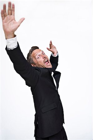 Studio portrait of businessman yelling Stock Photo - Premium Royalty-Free, Code: 6102-06025835