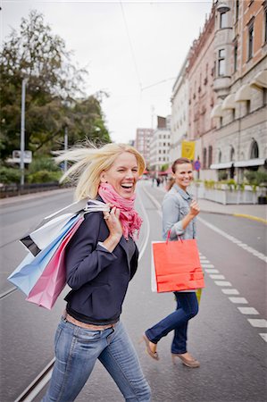 fun fashion street - Portrait of two women with shopping bags in street Stock Photo - Premium Royalty-Free, Code: 6102-06025963