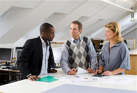 simsearch:6102-06026005,k - Coworkers having discussion in office Stock Photo - Premium Royalty-Free, Code: 6102-06025979
