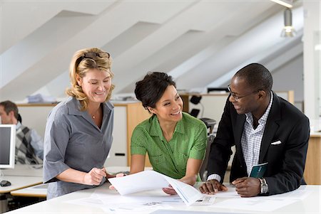 simsearch:6102-06026005,k - Coworkers having discussion in office Stock Photo - Premium Royalty-Free, Code: 6102-06025983