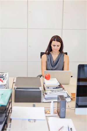 Businesswoman working in office environment Stock Photo - Premium Royalty-Free, Code: 6102-06026062