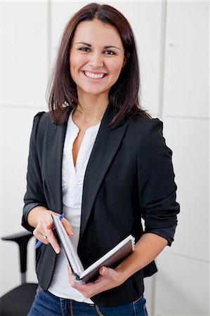 Happy businesswoman portrayed in office environment Stock Photo - Premium Royalty-Free, Code: 6102-06026069