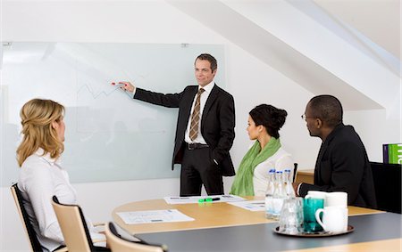 simsearch:6102-06026005,k - Business team at meeting Stock Photo - Premium Royalty-Free, Code: 6102-06026004