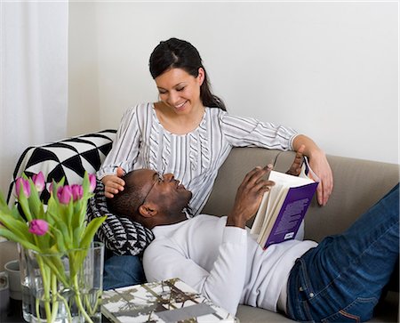 Couple sitting on sofa and looking at each other Stock Photo - Premium Royalty-Free, Code: 6102-06026026