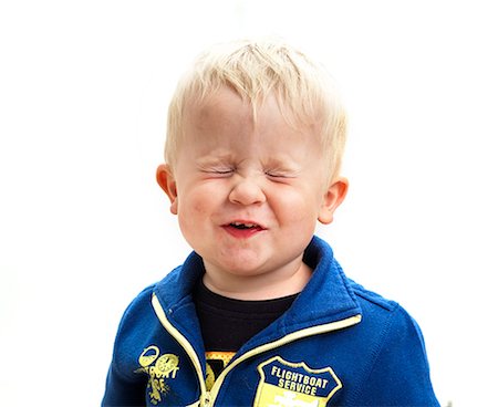 surprise boy - Portrait of boy with eyes closed, studio shot Stock Photo - Premium Royalty-Free, Code: 6102-06374468