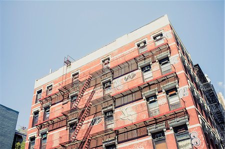 damaged houses - Low angle view of building with fire stairs Stock Photo - Premium Royalty-Free, Code: 6102-06374588