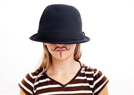 simsearch:6102-06336546,k - Portrait of girl wearing hat with fake moustache, studio shot Stock Photo - Premium Royalty-Free, Code: 6102-06336546