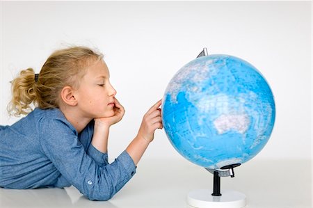 Portrait of girl reading globe Stock Photo - Premium Royalty-Free, Code: 6102-06336624