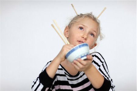 Mädchen mit Haar Brötchen Essen mit Stäbchen Stockbilder - Premium RF Lizenzfrei, Bildnummer: 6102-06336637