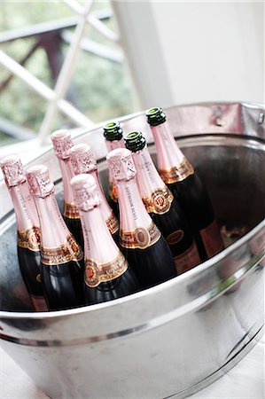 Champagne bottles in ice bucket Stock Photo - Premium Royalty-Free, Code: 6102-06336838