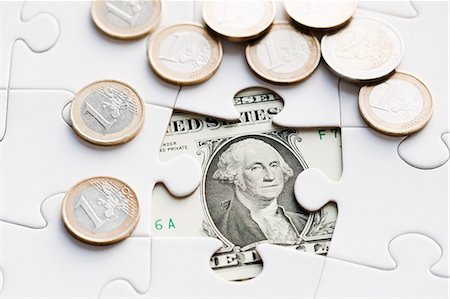 euro - Jigsaw puzzle revealing dollar bill Stock Photo - Premium Royalty-Free, Code: 6102-06336974