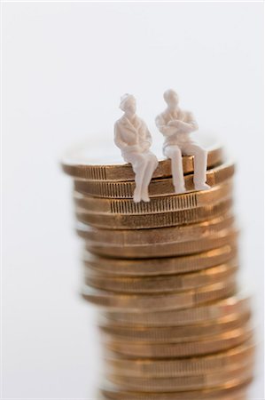 Stack of coins with figurines Stock Photo - Premium Royalty-Free, Code: 6102-06336984