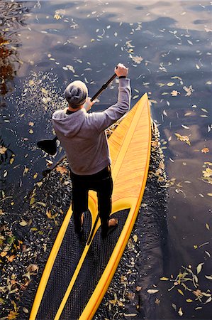 simsearch:6102-06336944,k - Man rowing paddle board in water, elevated view Stock Photo - Premium Royalty-Free, Code: 6102-06336935