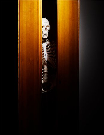 fear scared hiding - Skeleton in closet, close-up Stock Photo - Premium Royalty-Free, Code: 6102-06337044