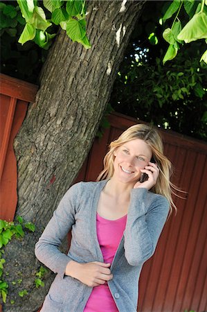 simsearch:6102-05655515,k - A blond woman using her mobile phone, Sweden. Stockbilder - Premium RF Lizenzfrei, Bildnummer: 6102-06470577