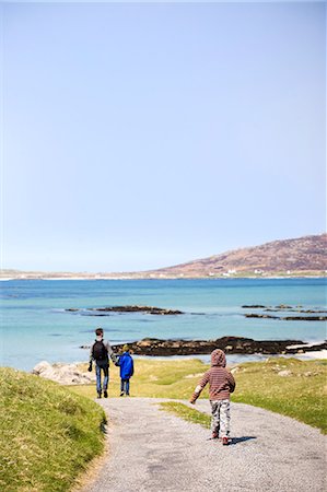 promenade - Father with two children walking toward sea Stock Photo - Premium Royalty-Free, Code: 6102-06470948