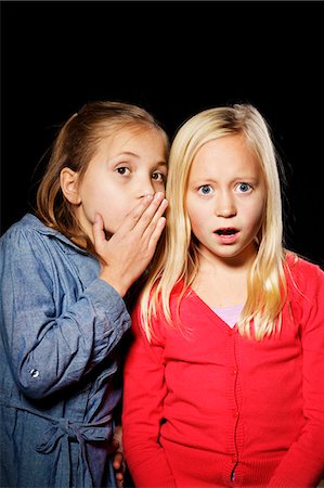 facial expressions fear - Studio shot of two girls whispering Stock Photo - Premium Royalty-Free, Code: 6102-06470985