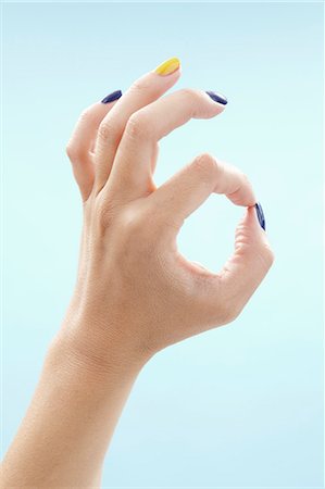 Womans hand making OK sign Stock Photo - Premium Royalty-Free, Code: 6102-06471099